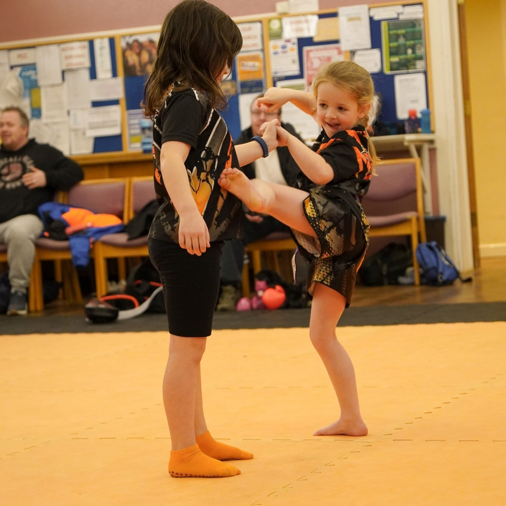 Junior student practising technique with partner support