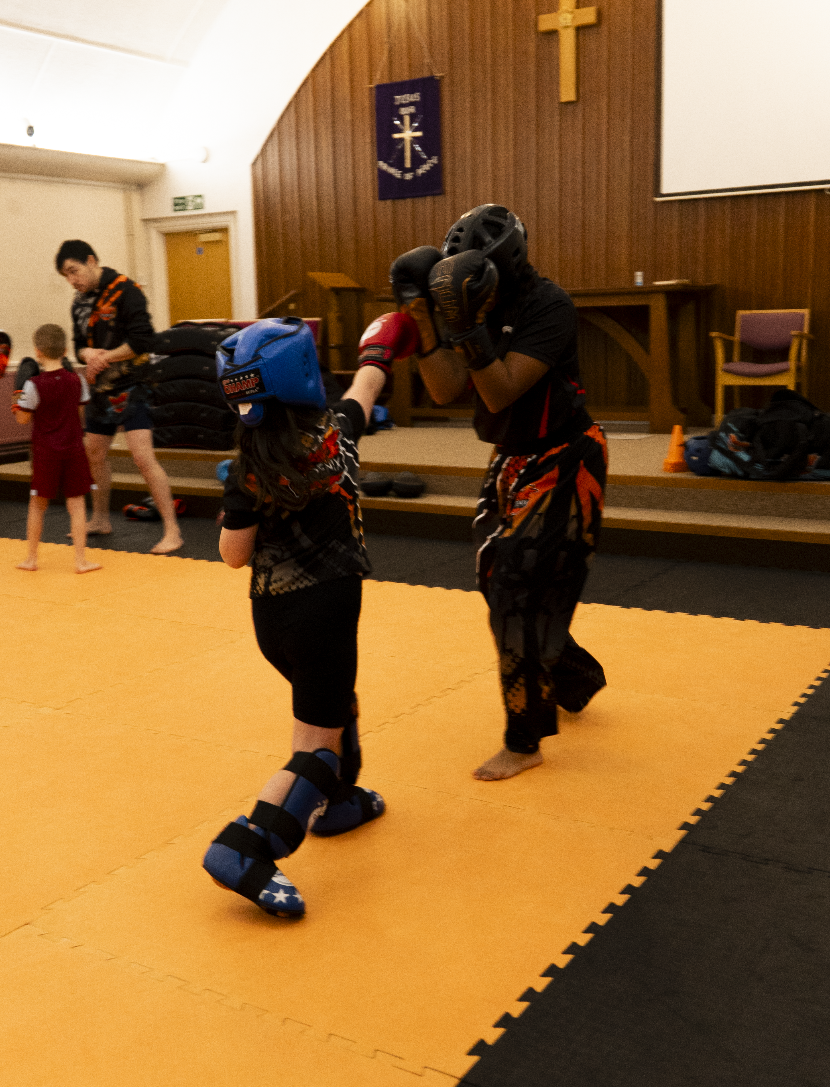 Junior sparring practice with coaching and control
