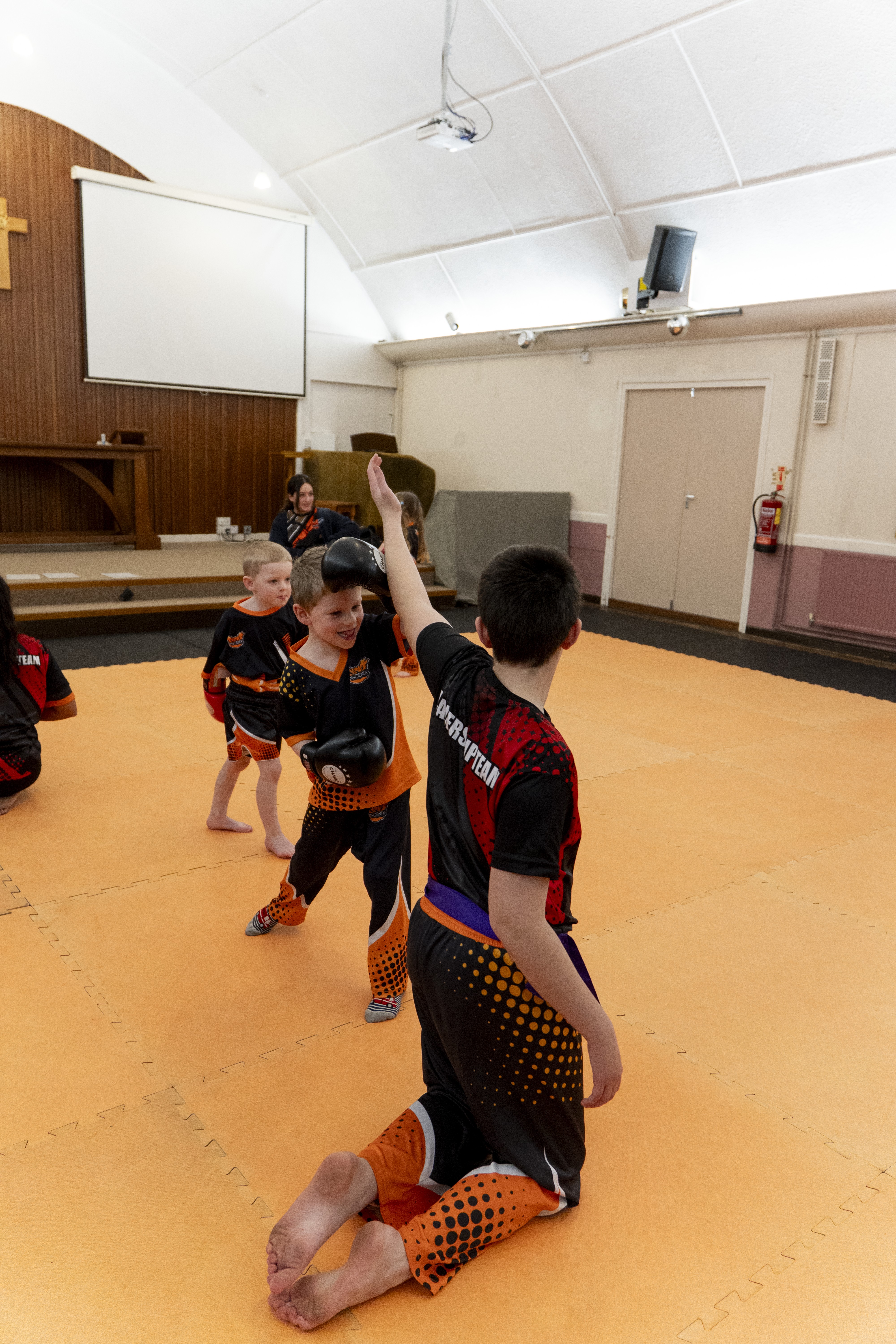 Child training with coach guidance during a structured class